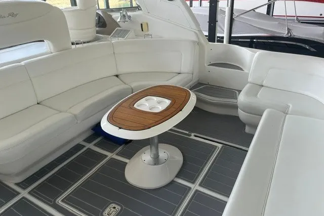 Slide: The Image of Luxurious 2005 Sea Ray Sundancer 260 interior with white seating and wooden table. - 26