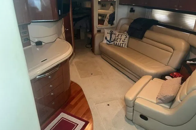 Slide: The Image of Interior of 2005 Sea Ray Sundancer 260 yacht with beige seating and kitchenette. - 25