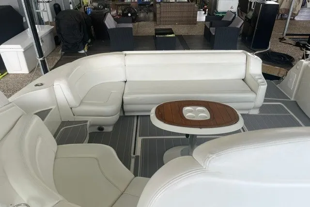 Slide: The Image of 2005 Sea Ray Sundancer 260 interior with white seating and wooden table. - 27
