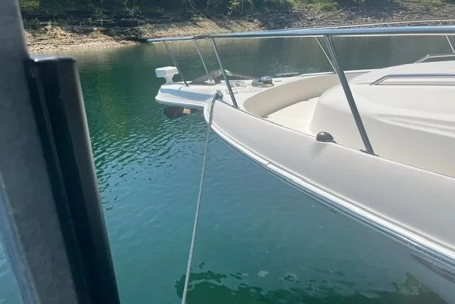 Slide: The Image of 2005 Sea Ray Sundancer 260 anchored on calm water near rocky shoreline. - 6