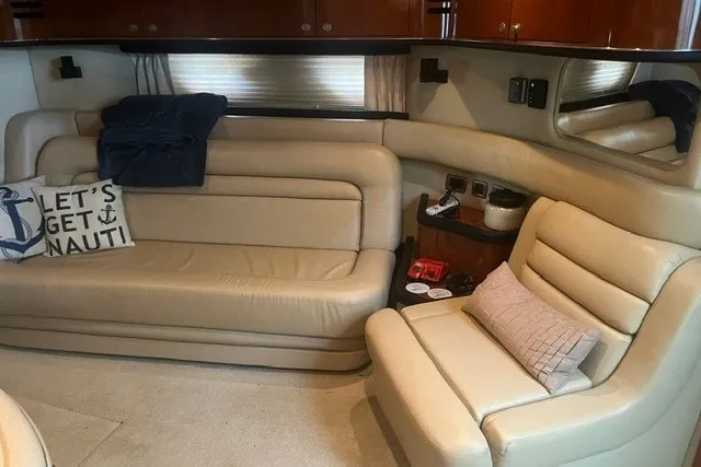 Slide: The Image of Interior of 2005 Sea Ray Sundancer 260 with beige leather seating and nautical decor. - 14