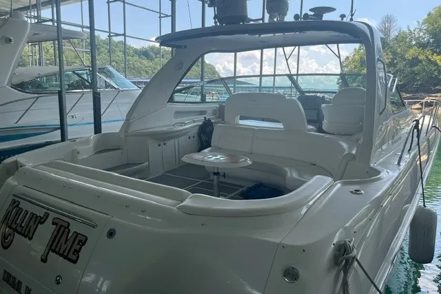 Slide: The Image of 2005 Sea Ray Sundancer 260 boat docked, featuring spacious seating and sleek design. - 1