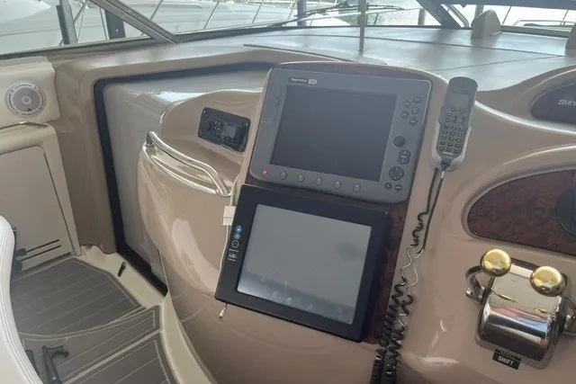 Slide: The Image of Helm of 2005 Sea Ray Sundancer 260 with navigation equipment and controls. - 10