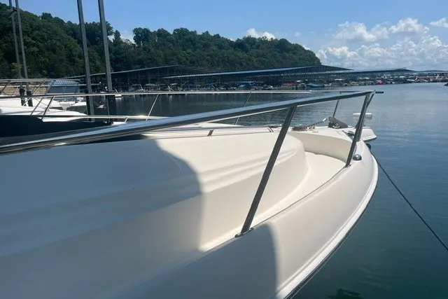 Slide: The Image of 2005 Sea Ray Sundancer 260 docked at a marina, with clear skies and calm waters. - 3