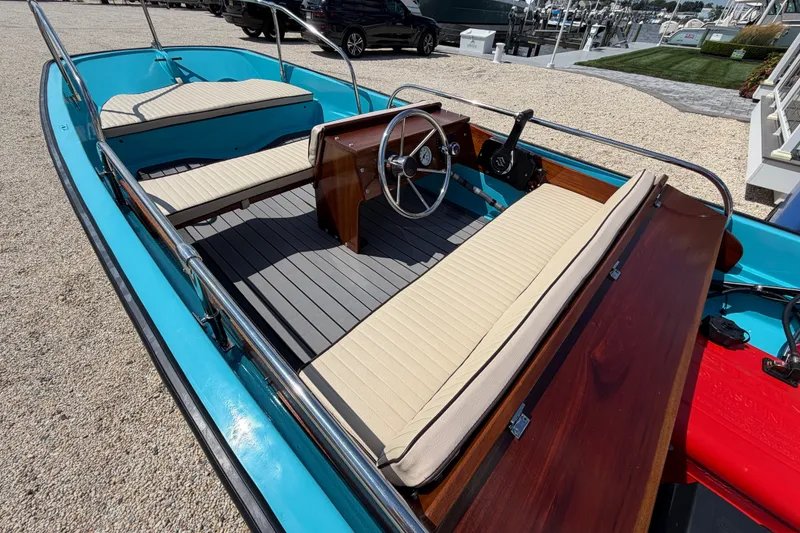 Slide: The Image of 1969 Boston Whaler 13 Super Sport boat with blue hull and beige seating. - 7