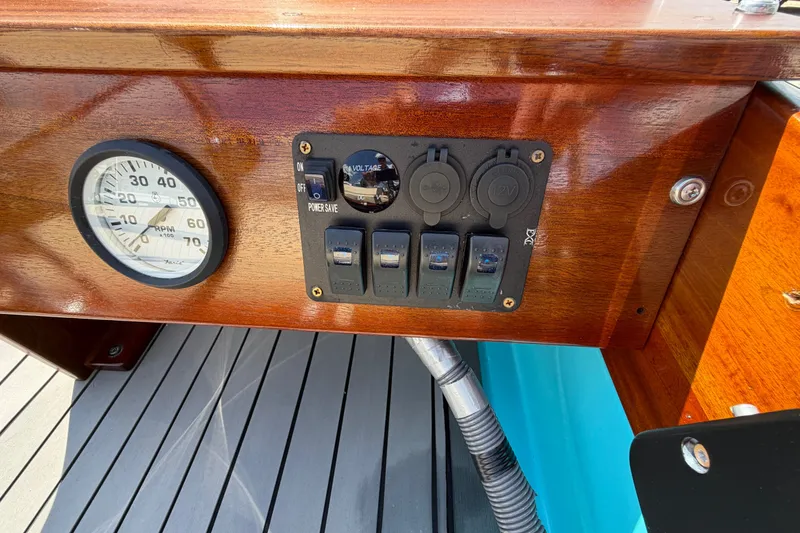 Slide: The Image of 1969 Boston Whaler 13 Super Sport dashboard with RPM gauge and control panel. - 13