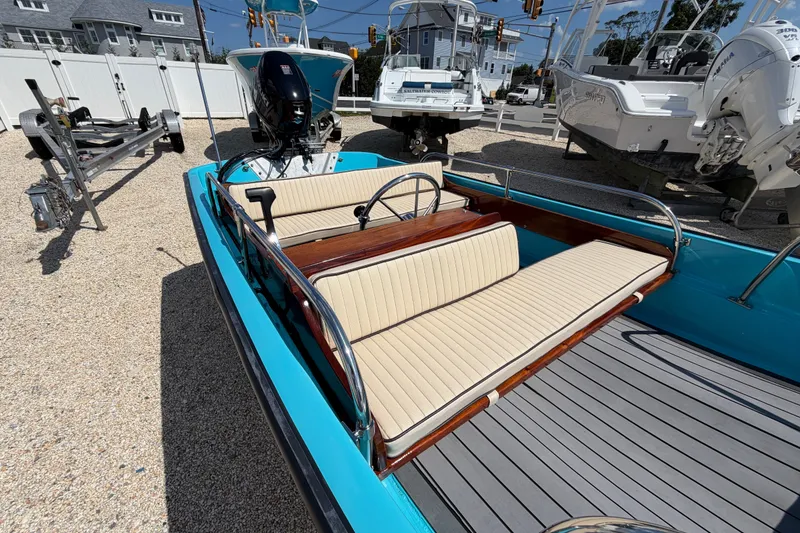 Slide: The Image of 1969 Boston Whaler 13 Super Sport boat with beige seating and blue exterior. - 11