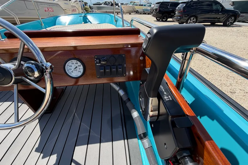 Slide: The Image of 1969 Boston Whaler 13 Super Sport boat dashboard with steering wheel and controls. - 16