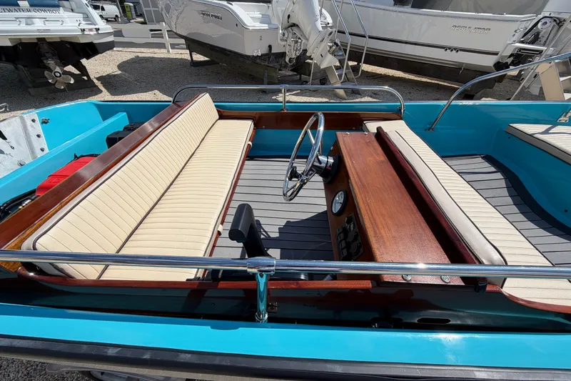 Slide: The Image of 1969 Boston Whaler 13 Super Sport boat interior with classic wood and beige seating. - 12