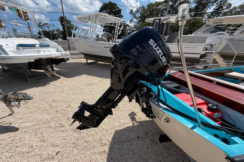 Slide: The Image of 1969 Boston Whaler 13 Super Sport with Suzuki outboard motor in a boatyard. - 3