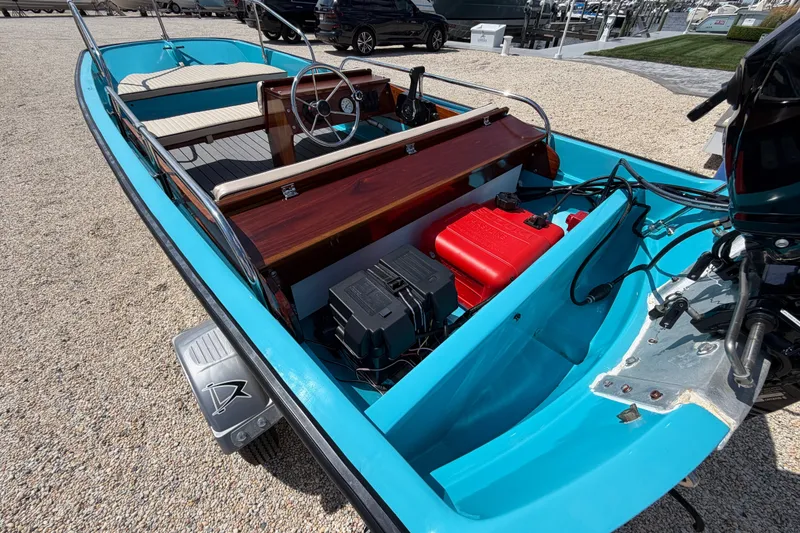 Slide: The Image of 1969 Boston Whaler 13 Super Sport boat with blue interior and wooden dashboard. - 6