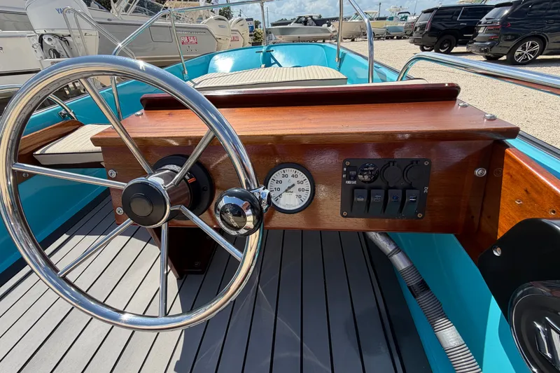 Slide: The Image of 1969 Boston Whaler 13 Super Sport boat dashboard with steering wheel and gauges. - 14