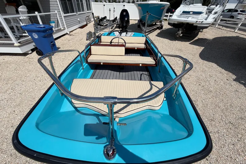 Slide: The Image of 1969 Boston Whaler 13 Super Sport boat with blue hull and beige seating. - 9