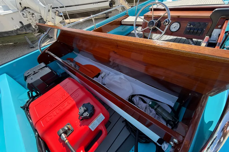 Slide: The Image of 1969 Boston Whaler 13 Super Sport interior with wooden dashboard and red fuel tank. - 17