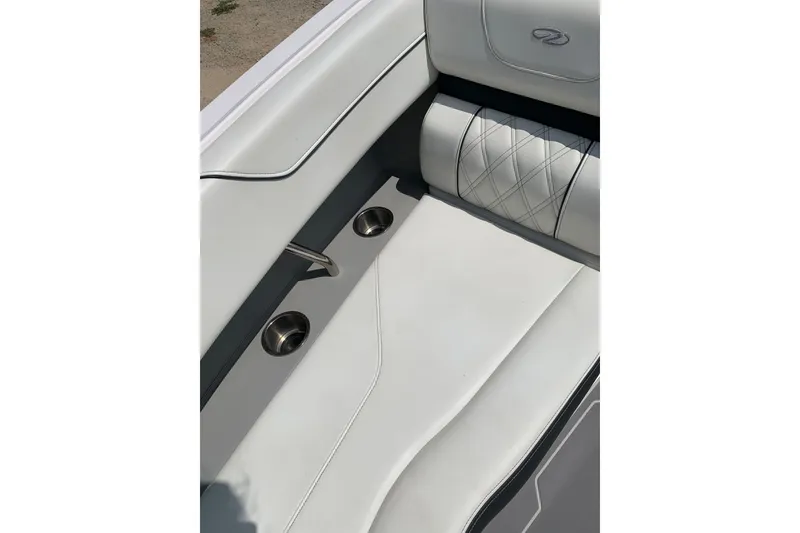 Slide: The Image of 2020 Regal LS6 Surf boat interior with white leather seating and cup holders. - 25