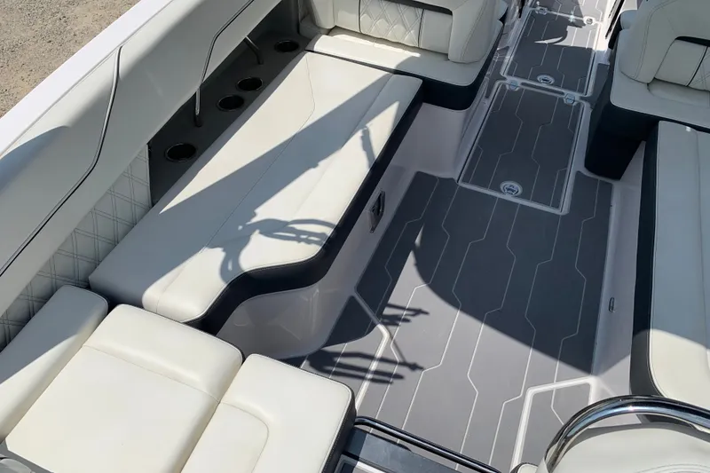 Slide: The Image of Interior of a 2020 Regal LS6 Surf boat with white seating and gray flooring. - 14