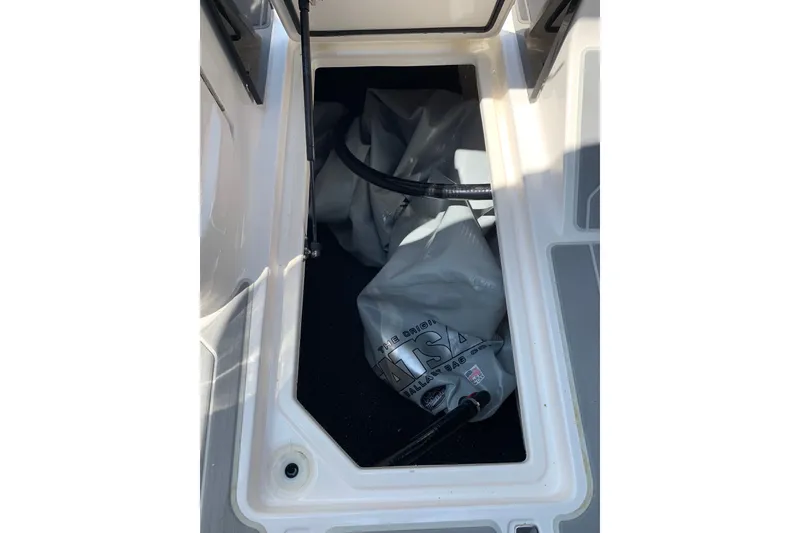 Slide: The Image of 2020 Regal LS6 Surf boat storage compartment with ballast bag inside. - 54