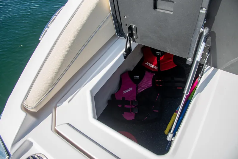Slide: The Image of Manufacturer Provided Image: Storage compartment on a 2020 Regal LS6 Surf boat with life jackets. - 96