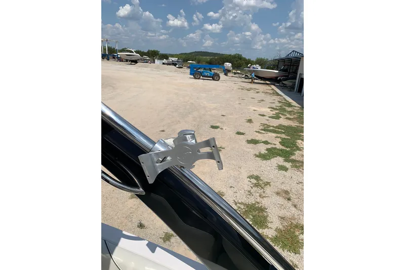 Slide: The Image of 2020 Regal LS6 Surf boat with a mounted accessory in a sunny outdoor setting. - 48