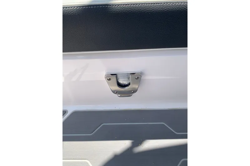 Slide: The Image of 2020 Regal LS6 Surf boat interior detail with metal latch and textured flooring. - 37