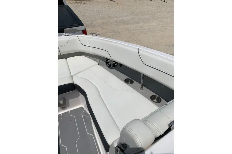 Slide: The Image of 2020 Regal LS6 Surf boat interior with white seating and cup holders. - 22