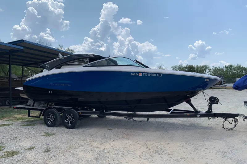 Slide: The Image of 2020 Regal LS6 Surf boat on trailer under cloudy sky. - 78