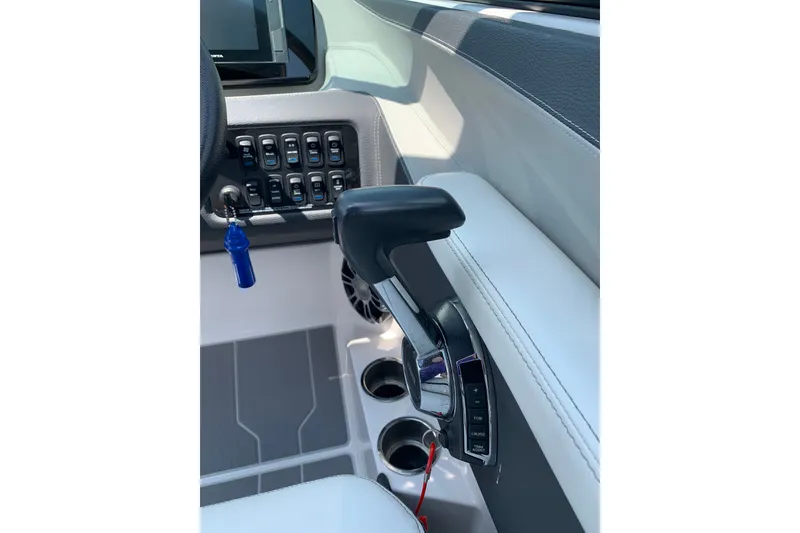 Slide: The Image of Control panel and throttle of 2020 Regal LS6 Surf boat interior. - 33