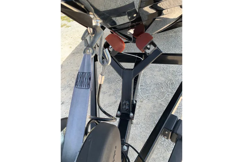 Slide: The Image of Trailer hitch and winch of a 2020 Regal LS6 Surf boat on gravel surface. - 80