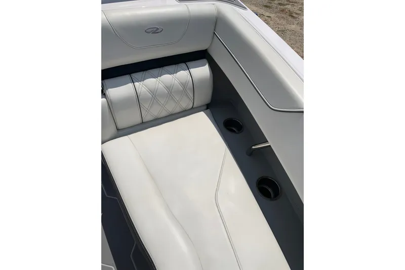 Slide: The Image of 2020 Regal LS6 Surf boat interior with white leather seating and cup holders. - 24
