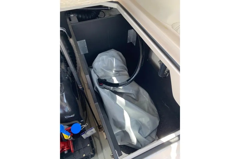 Slide: The Image of Storage compartment of a 2020 Regal LS6 Surf boat, featuring equipment and accessories. - 58