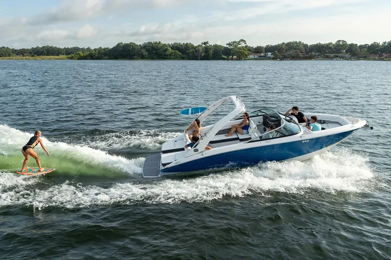 Slide: The Image of Manufacturer Provided Image: 2020 Regal LS6 Surf boat towing a wakeboarder on a lake. - 87