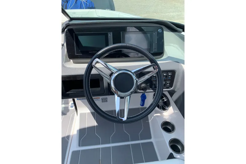 Slide: The Image of 2020 Regal LS6 Surf boat dashboard with steering wheel and control panel. - 30