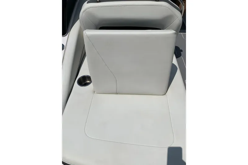 Slide: The Image of 2020 Regal LS6 Surf boat seat with white upholstery and cup holder. - 42