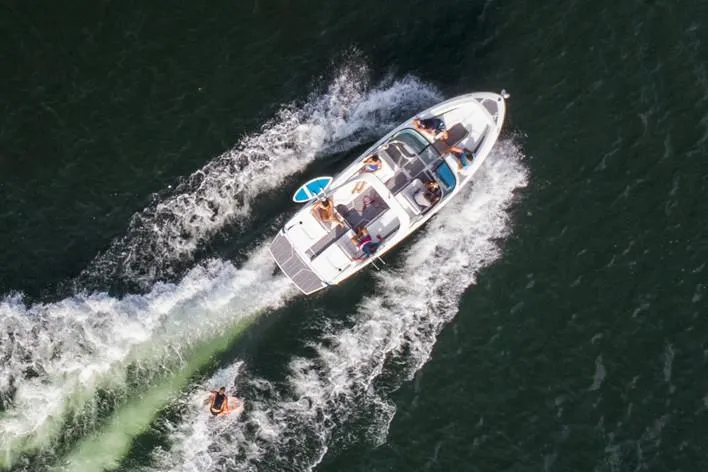 Slide: The Image of Manufacturer Provided Image: Aerial view of 2020 Regal LS6 Surf boat towing a wakeboarder. - 86