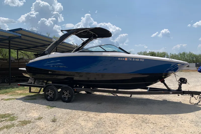 The Image of 2020 Regal LS6 Surf boat on trailer under sunny sky. - 0