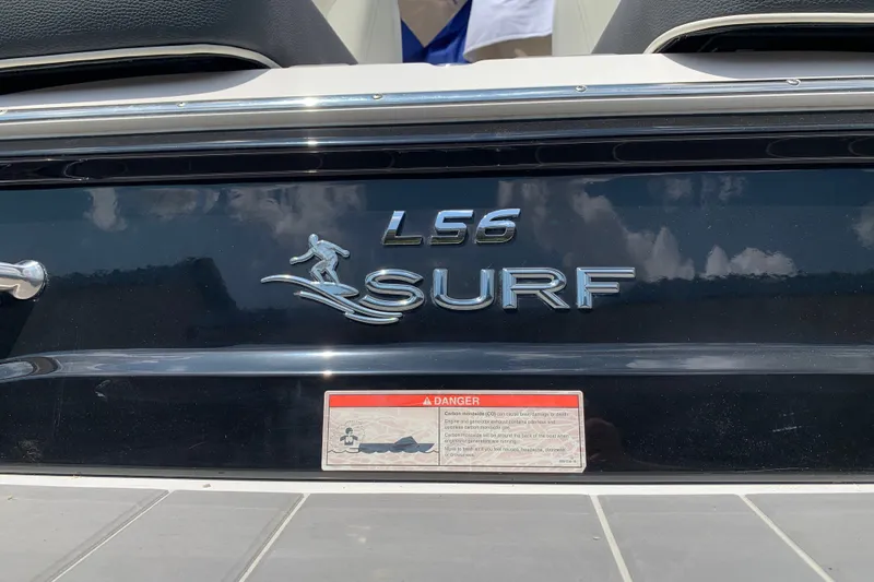Slide: The Image of 2020 Regal LS6 Surf boat logo with warning label on black surface. - 68