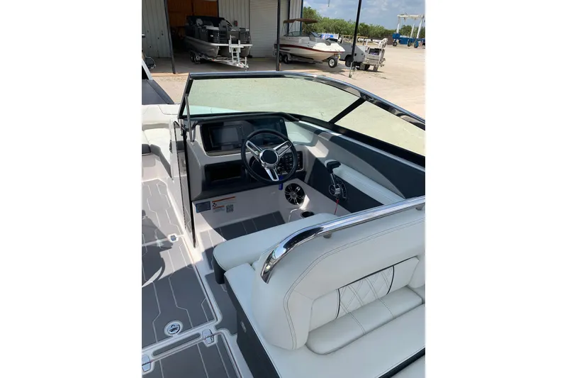 Slide: The Image of 2020 Regal LS6 Surf boat interior with sleek dashboard and comfortable seating. - 20