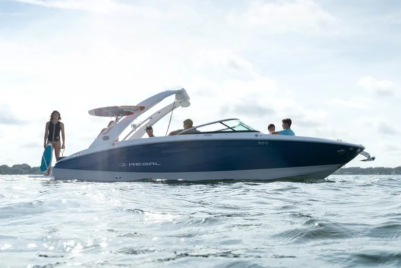 Slide: The Image of Manufacturer Provided Image: 2020 Regal LS6 Surf boat on water with people onboard. - 90