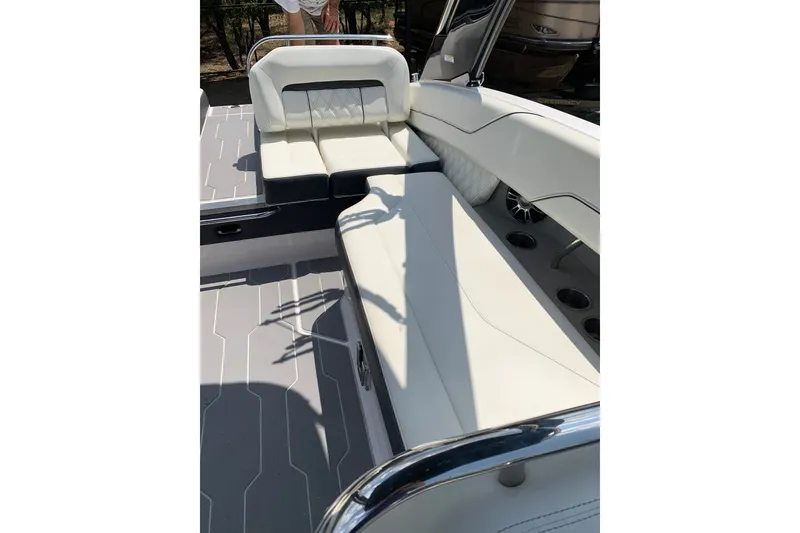 Slide: The Image of 2020 Regal LS6 Surf boat interior with white seating and cup holders. - 29