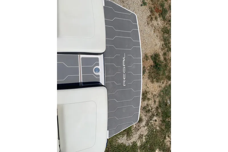 Slide: The Image of 2020 Regal LS6 Surf boat swim platform with logo, featuring sleek design and textured surface. - 41