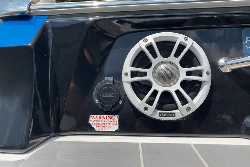 Slide: The Image of 2020 Regal LS6 Surf boat speaker and warning label on swim platform. - 67