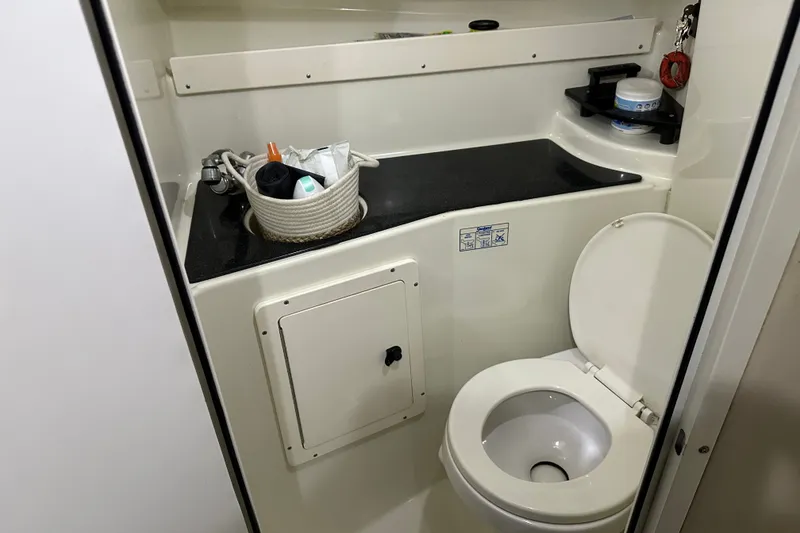 Slide: The Image of 2002 Hydra-Sports Vector 2800 WA boat bathroom with toilet and countertop storage. - 8
