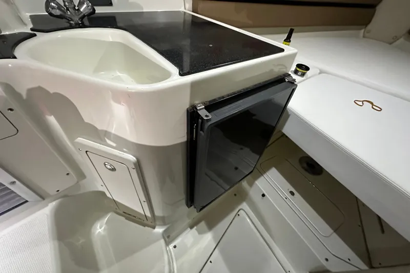 Slide: The Image of 2002 Hydra-Sports Vector 2800 WA boat interior with sink and storage. - 12