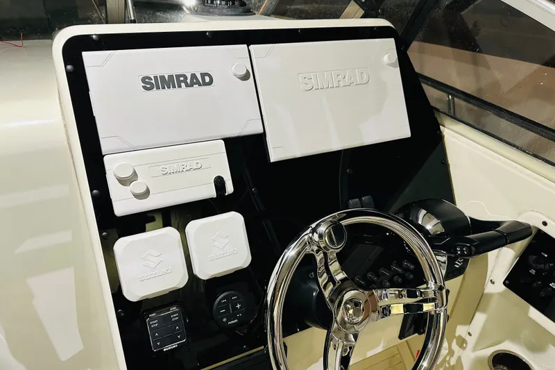 Slide: The Image of 2002 Hydra-Sports Vector 2800 WA dashboard with Simrad navigation equipment and Suzuki controls. - 7