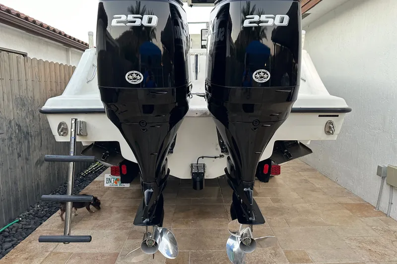 Slide: The Image of 2002 Hydra-Sports Vector 2800 WA with twin 250 horsepower engines, docked on a tiled surface. - 4
