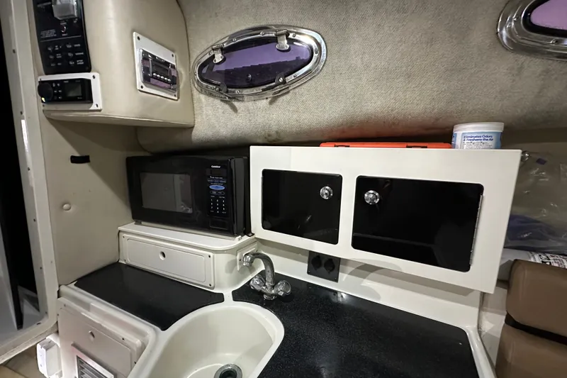 Slide: The Image of 2002 Hydra-Sports Vector 2800 WA cabin interior with microwave, sink, and storage cabinets. - 11