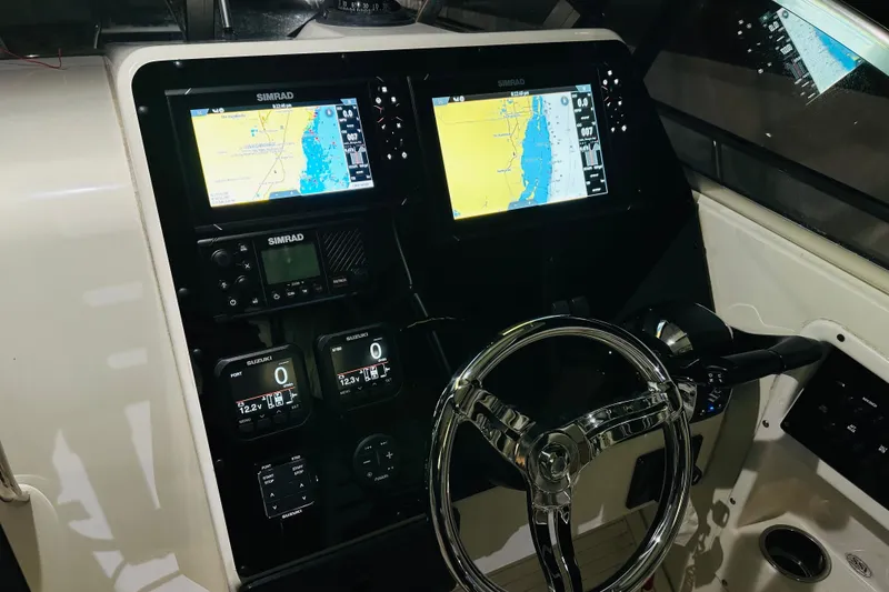 Slide: The Image of 2002 Hydra-Sports Vector 2800 WA dashboard with dual Simrad displays and steering wheel. - 6