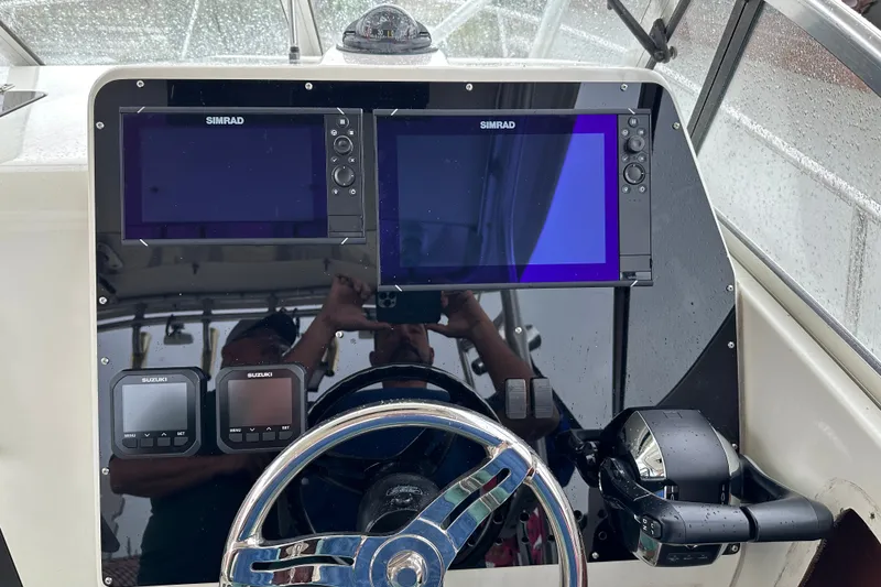 Slide: The Image of Console of 2002 Hydra-Sports Vector 2800 WA with Simrad displays and Suzuki controls. - 5