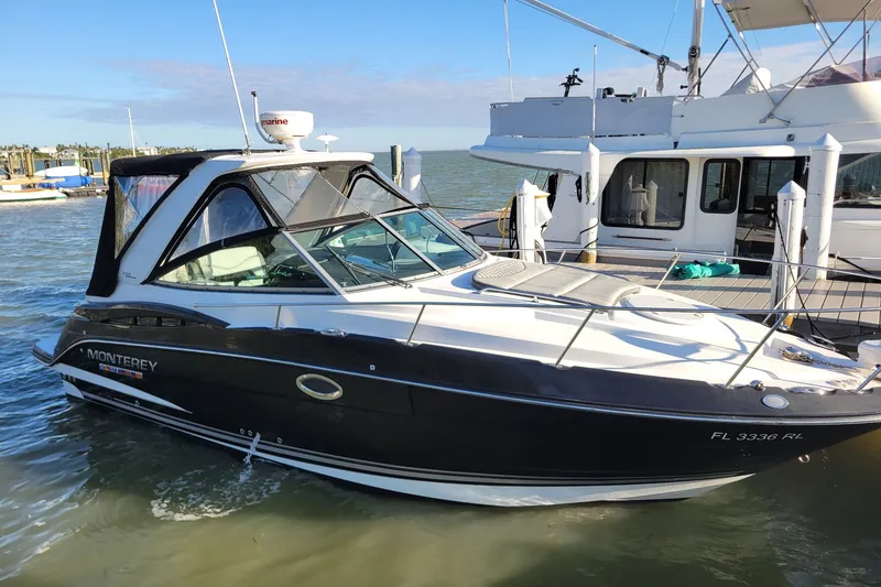 Slide: The Image of 2017 Monterey 295 Sport Yacht docked in a marina, sunny day, calm waters. - 34
