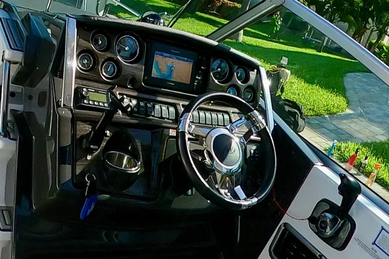 Slide: The Image of Cockpit of 2017 Monterey 295 Sport Yacht with steering wheel and navigation display. - 30